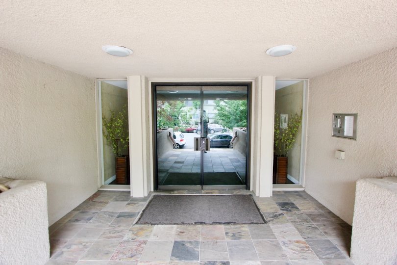 In sunny day the entrance is looking good and glass door is making good and attractive plants and lightings