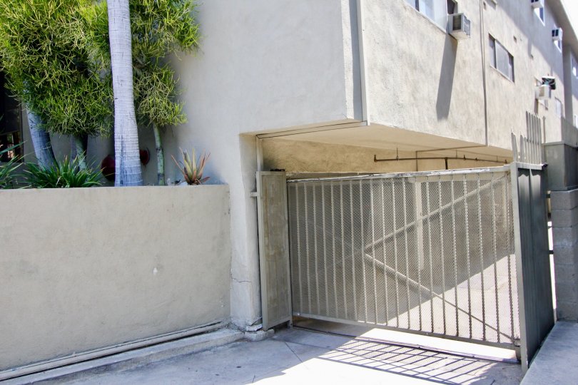 A white building at 938 Palm with a white fence and palm trees