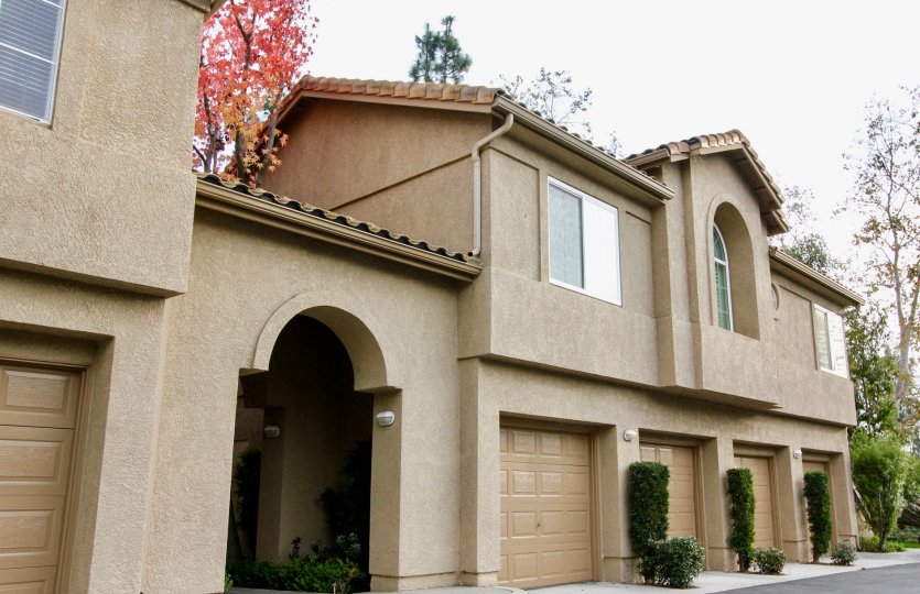 Condominium with four car garage and metal roof with landscaping
