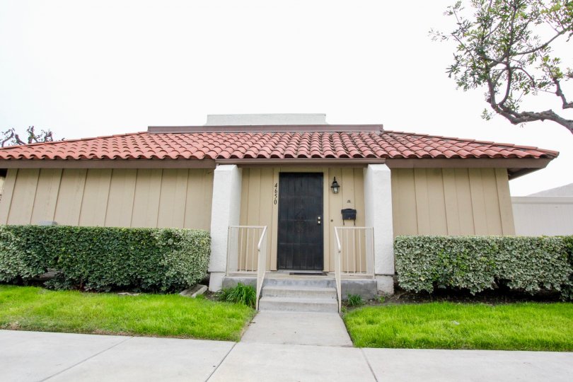 THE SMALL HOUSE IN BUENA PARK, WHICH SHOWS LAWN, CROTON PLANTS ON BOTHSIDE, NUMBER ON THE WALL IS THERE