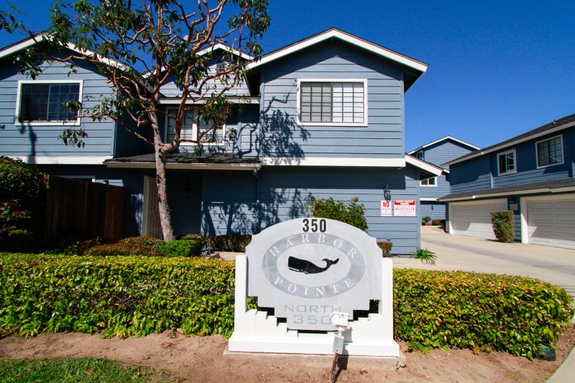 Sunny day blue sky in front of Harbor Pointe North community in Costa Mesa, CA
