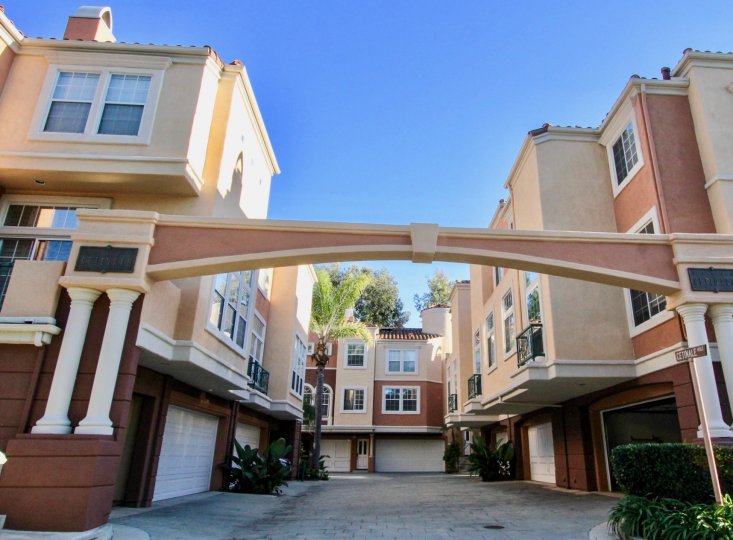An arched courtyard in the Corte Bella community surrounded by three-storey houses.