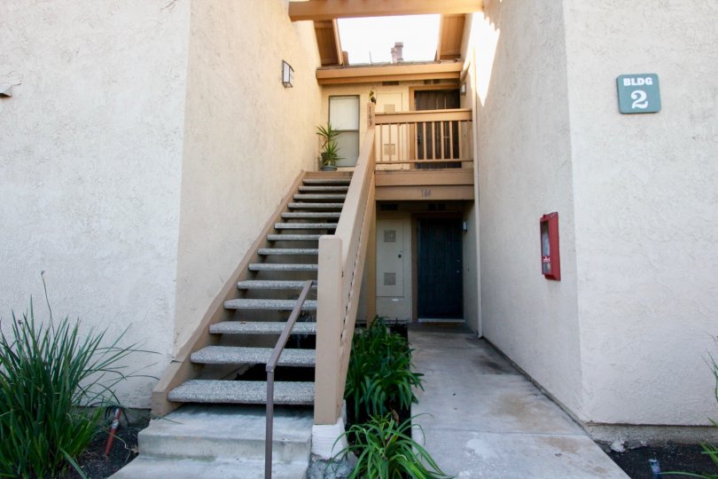 THE HOUSE WITH PLANTS, STEPS, NUMBER BOARD ON THE WALL IN THE CITY OF IRVINE