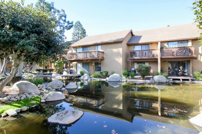 a warm day in the orangetree lake condos with a building that has water and stones and roofless top