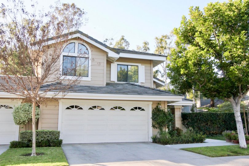 A two story home with two garages with small windows at Ridge Garden Homes in Irvine CA