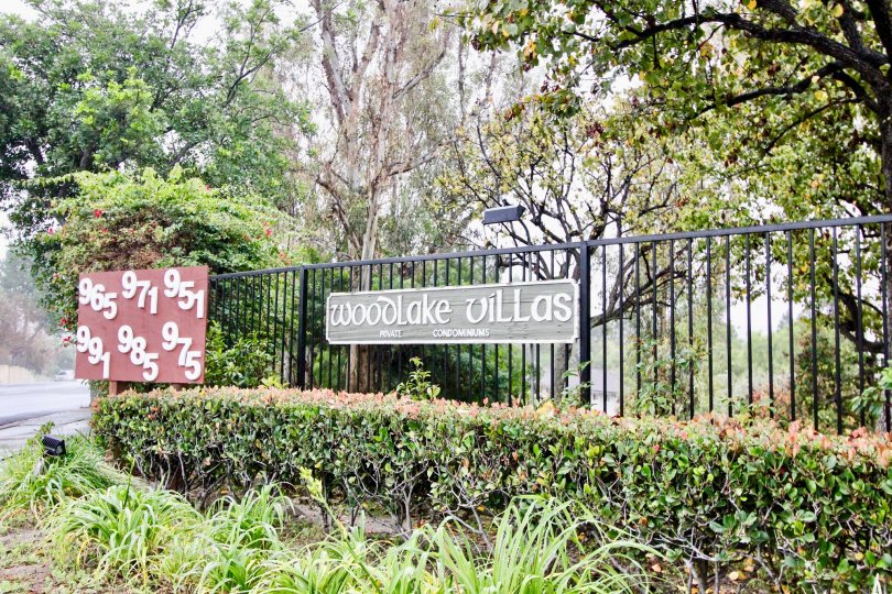Greenish park near villas having name plate in Woodlake Villas of La Habra