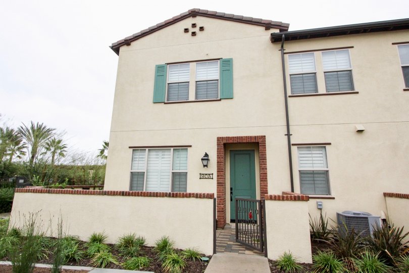 A villa with main gate and plants in front of El Paseo of Lake Forest
