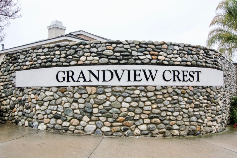 Circular multi-colored stone wall surrounding Grandview Crest in California.