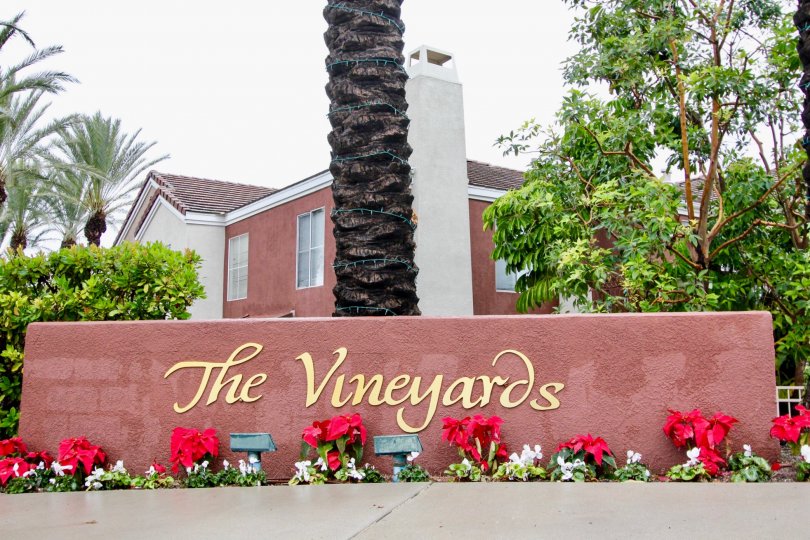 Flower and tree lined, festive entrance to The Vineyards in Lake Forest