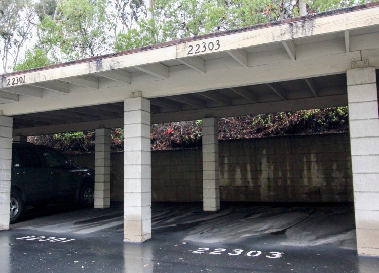 Two empty parking spots on a wet day in the Vista Verde Townhomes in Lake Forest California.