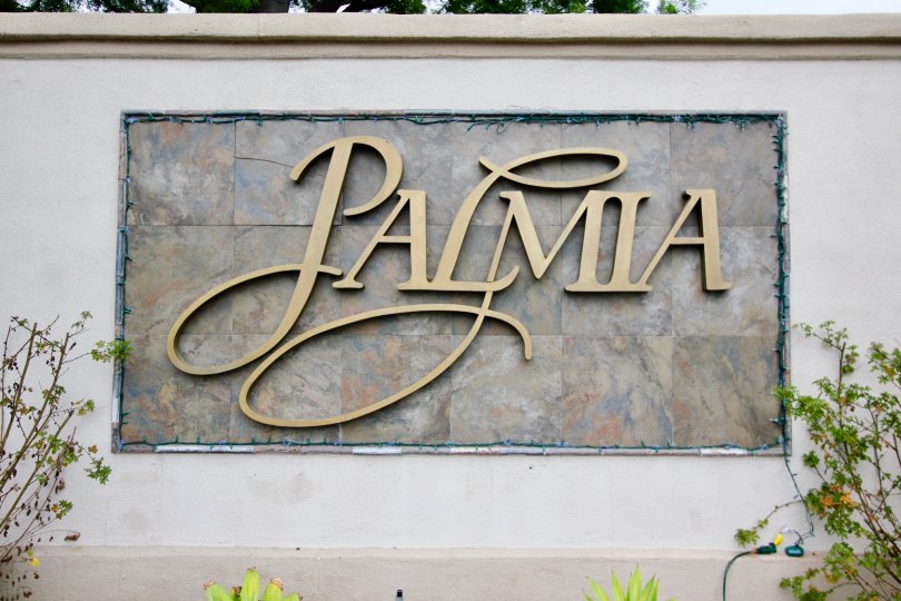 A view of a apartment complex called Palmia in Mission Viejo, California with some shrubbery next to it
