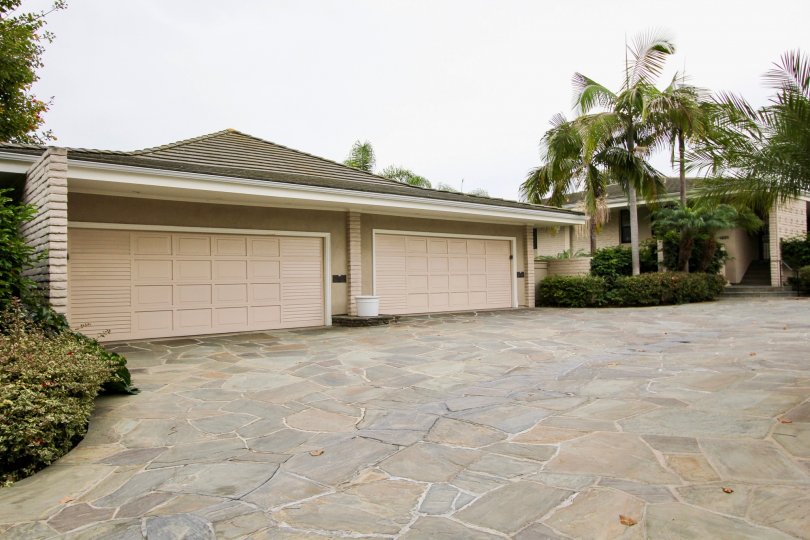 A day in the Granville with a garage gate and palm trees.