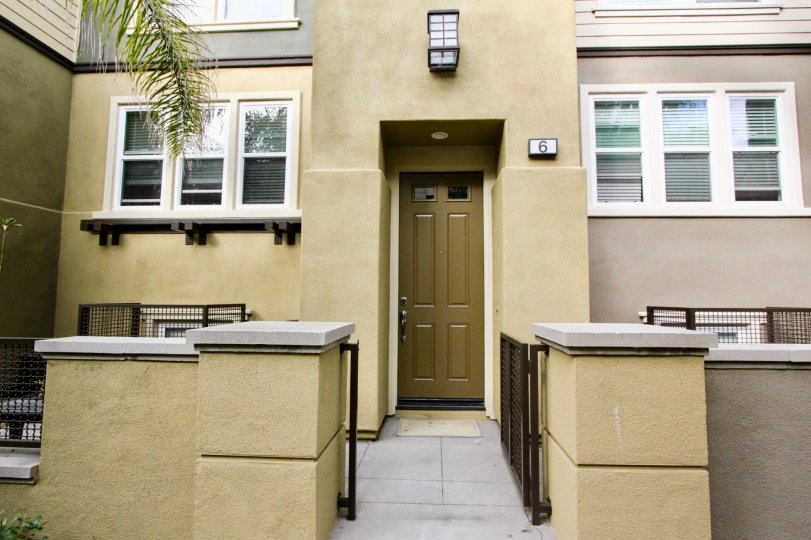 a pleasant day in the one nautical mile with a house that has short compound wall and a steel gate