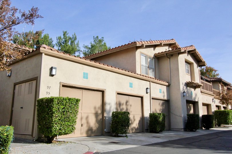 Front view of residences in Sycmore Glen in Tustin, California. Single car garages and balconies for the residents.