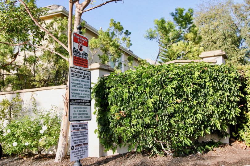 Green trees with sign boards near villa of Magnolia of Rancho Santa Margarita