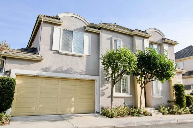 A yellow garage door sits on a gray building in the Magnolia community