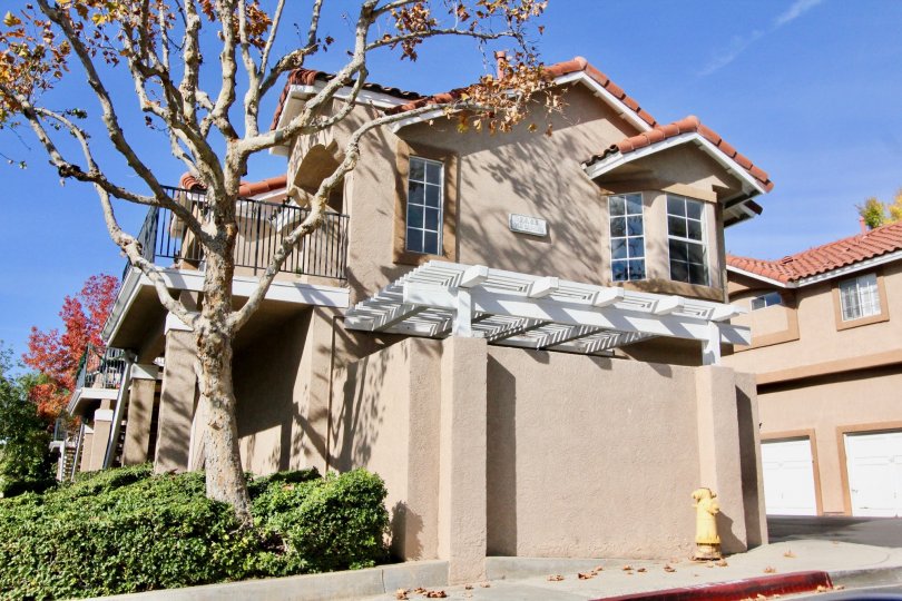 A sunny day in the area of Mission Courts, outside, trees, condo, garage, balcony, windows