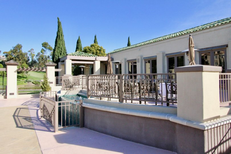 A sunny day in the area of Marbella Golf Villas, outside, condos, table, chairs, fence