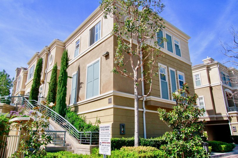 Vantage Santa Ana California is having traditional building and plants seems to touch sky with blue glass windows