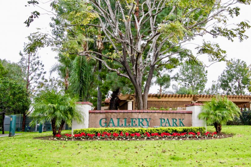 Awesome view of park area with lawn and board with trees in Corte Villa of Tustin