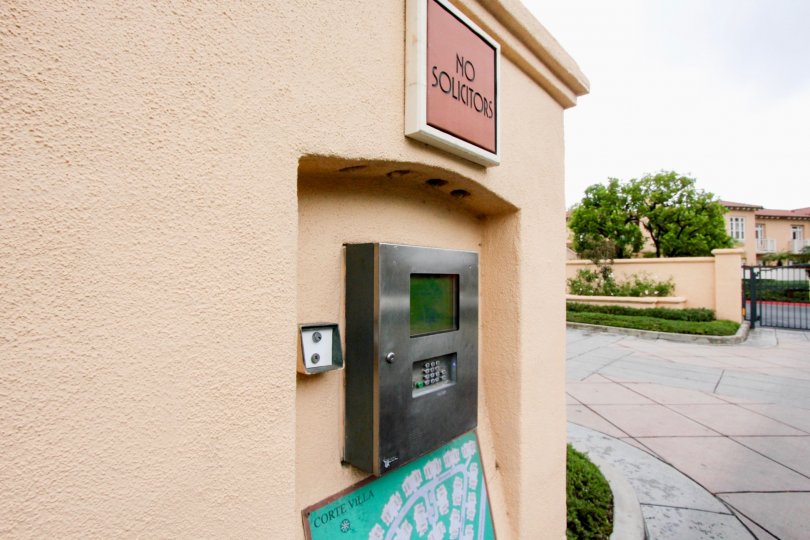 A sign reading "No Solicitors" sits above a callbox at the Corte Villa townhomes