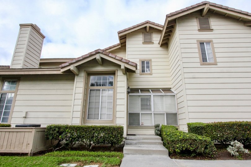 Two-storey residence with wooden cladding and brownish paint in the Sycamore Glen community.