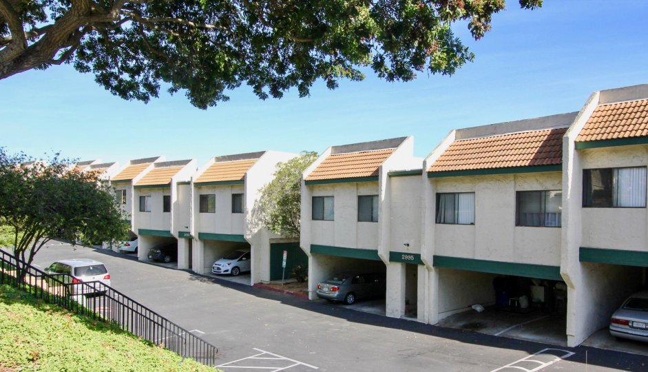 Multiple off white units with covered parking located in Forest Park Plaza of Clairemont Mesa, California
