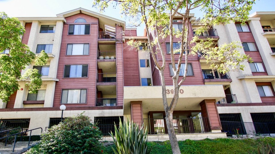 Five story red and white building with parking at Sunrise Point in College Area CA