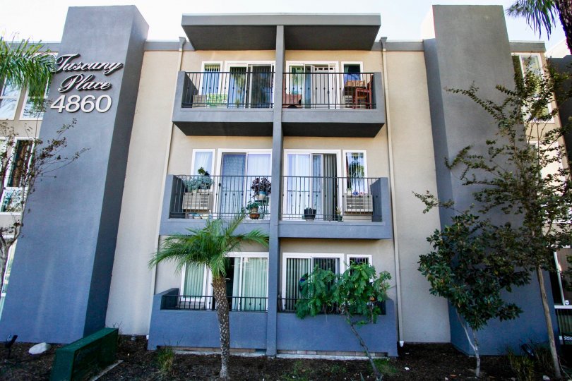 Three story residential building with trees at Tuscany Place in College Area California