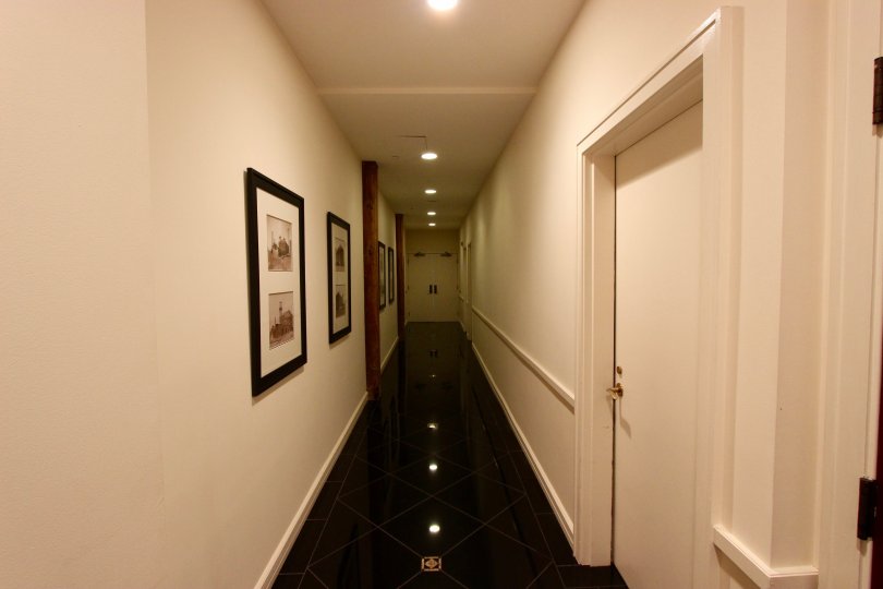 Black shiny tiles on a diagonal line a dim hallway at Cityfront Terrace