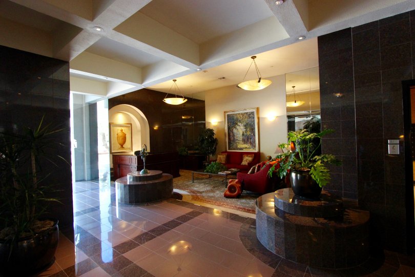 Shiny black tiles line the walls near the elevators at Harbor Club