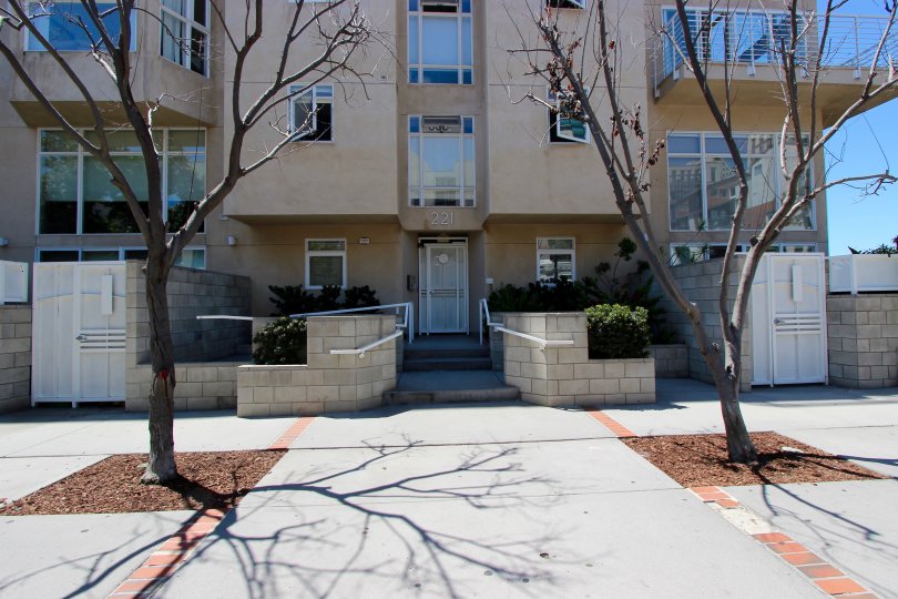 A SUNNY DAY IN THE ISLAND LOFTS WITH BUILDING AND SOME TREES