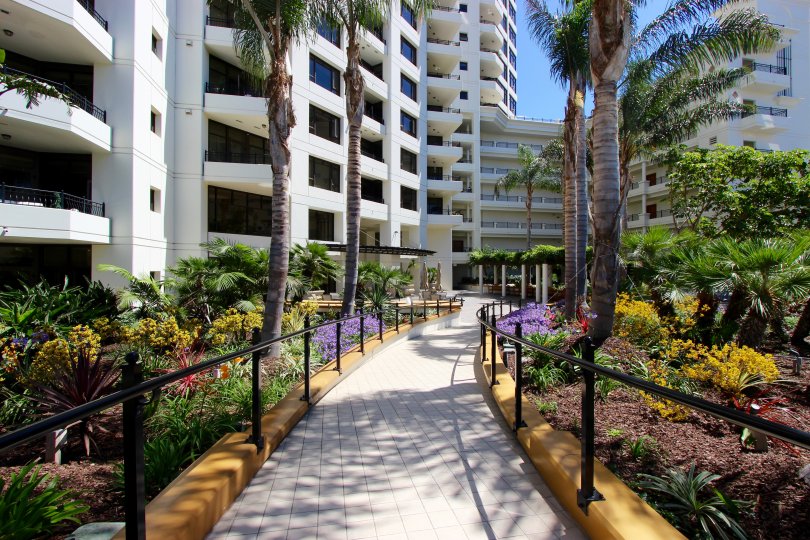 Brick walkway lined with colorful flowers & plants in Park Place in Downtown San Diego CA