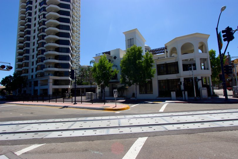 Pedestrian crossing with adjacent railway crossing and wide roadway next to Park Place in Downtown San Diego, CA.