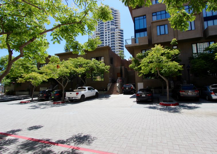 THE APARTMENT IN THE WATERMARK WITH THE CAR PARKING, TREES, GLASS WINDOWS.
