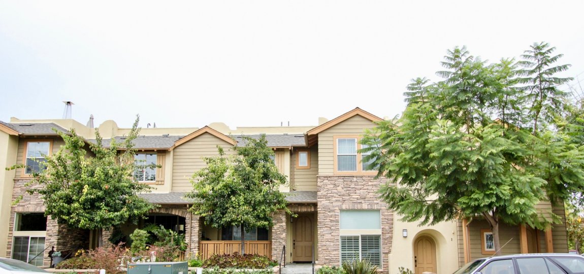 Two story units with a stone wall at the Paseo La Jolla Community in La Jolla CA