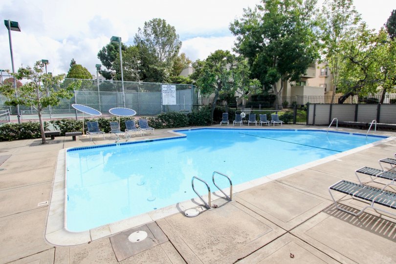 Woodlands West I pool and tennis court with chairs La Jolla California