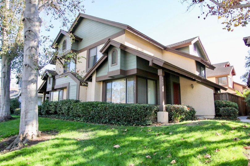 VERY BEAUTIFUL HOUSE IN FRONT OF GRASS AND TREES AND THE HOUSE LIKE SO ATTRACTIVE