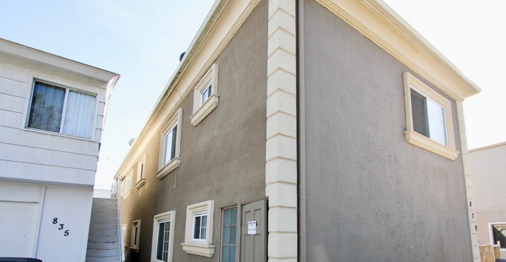 Side view of grey residence with white trim of San Fernando Bay Villas in Mission Beach.