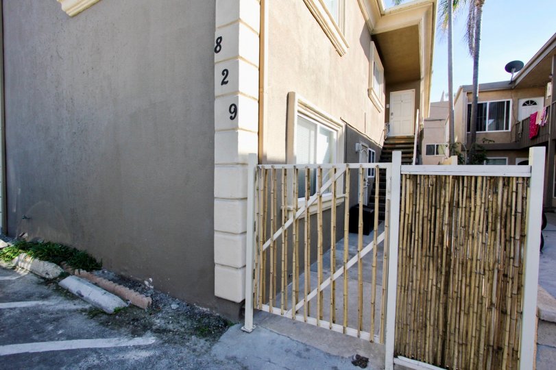 A door is inset from the street as a palm grows behind hte home at the San Fernando Bay Villas of Mission Beach, California