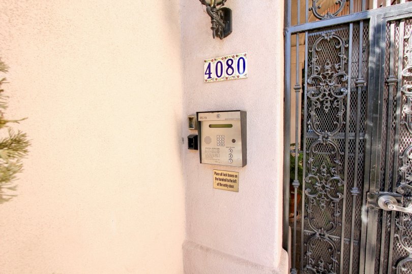 A gate with a street number and intercom at Villa Portofino on Front, Mission Hills, CA