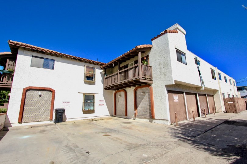 A sunny day in the area of Hawley Villas, parking lot, garages, balcony, flower, window