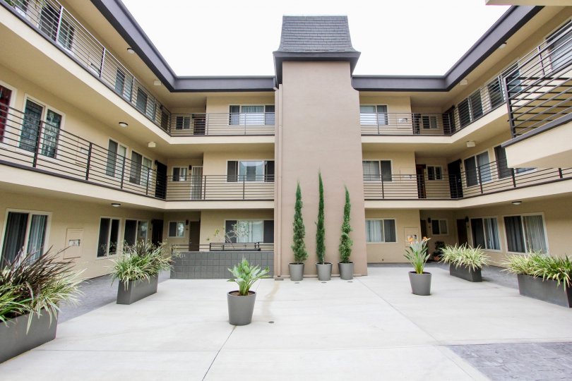 Walkways between the the condos at Louisiana Condominiums open to an open patio with plants in North Park, CA.