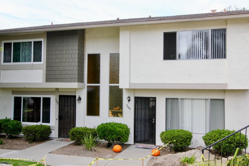 Bay Shores, Oceanside, California, trimmed bushes, black door.