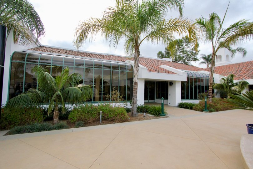 In the Ocean Hills Country Club communtity a small building has palm trees in front.