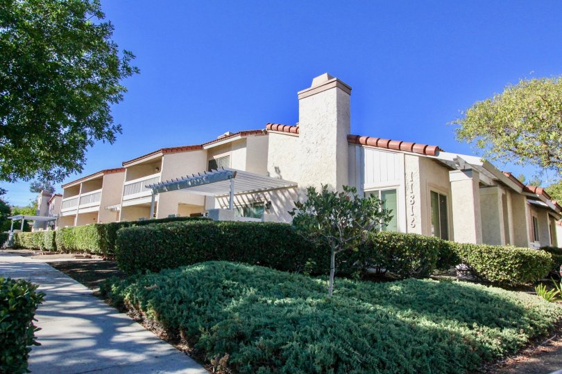 Residential buildings near plants and trees at Bernardo Terrace in Rancho Bernardo California