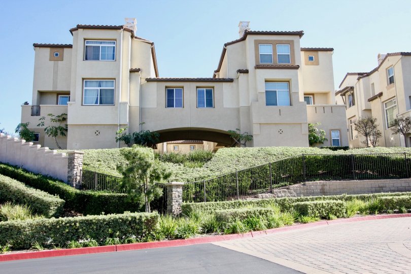 THE BUILDING IN THE CORONADO RANCH WITH THE GRASSES, STEEL WALL, PATHWAY, BALCONIS, PLANTS