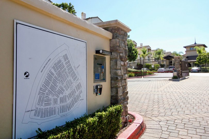Community map, communication panel and gated entryway on a brick paved road at Coronado Ranch