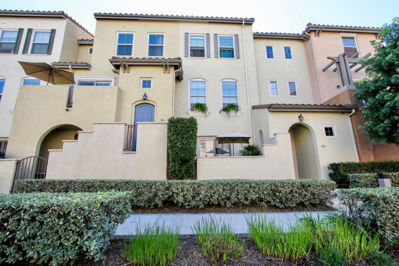 A sunny day in the area of Coronado Ranch, outside, condo, bushes, plants, umbrella