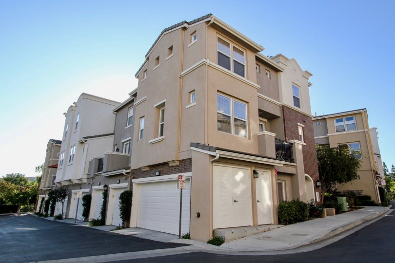 A sunny day in the area of Village Square, outside, condos, balcony, trees, garage